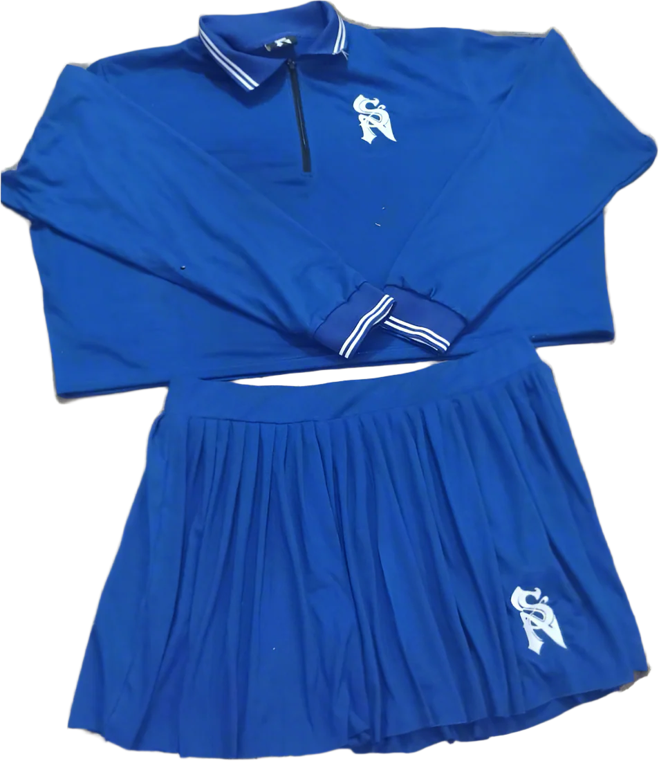 Blue athletic outfit with a skirt and long-sleeve top on a neutral background