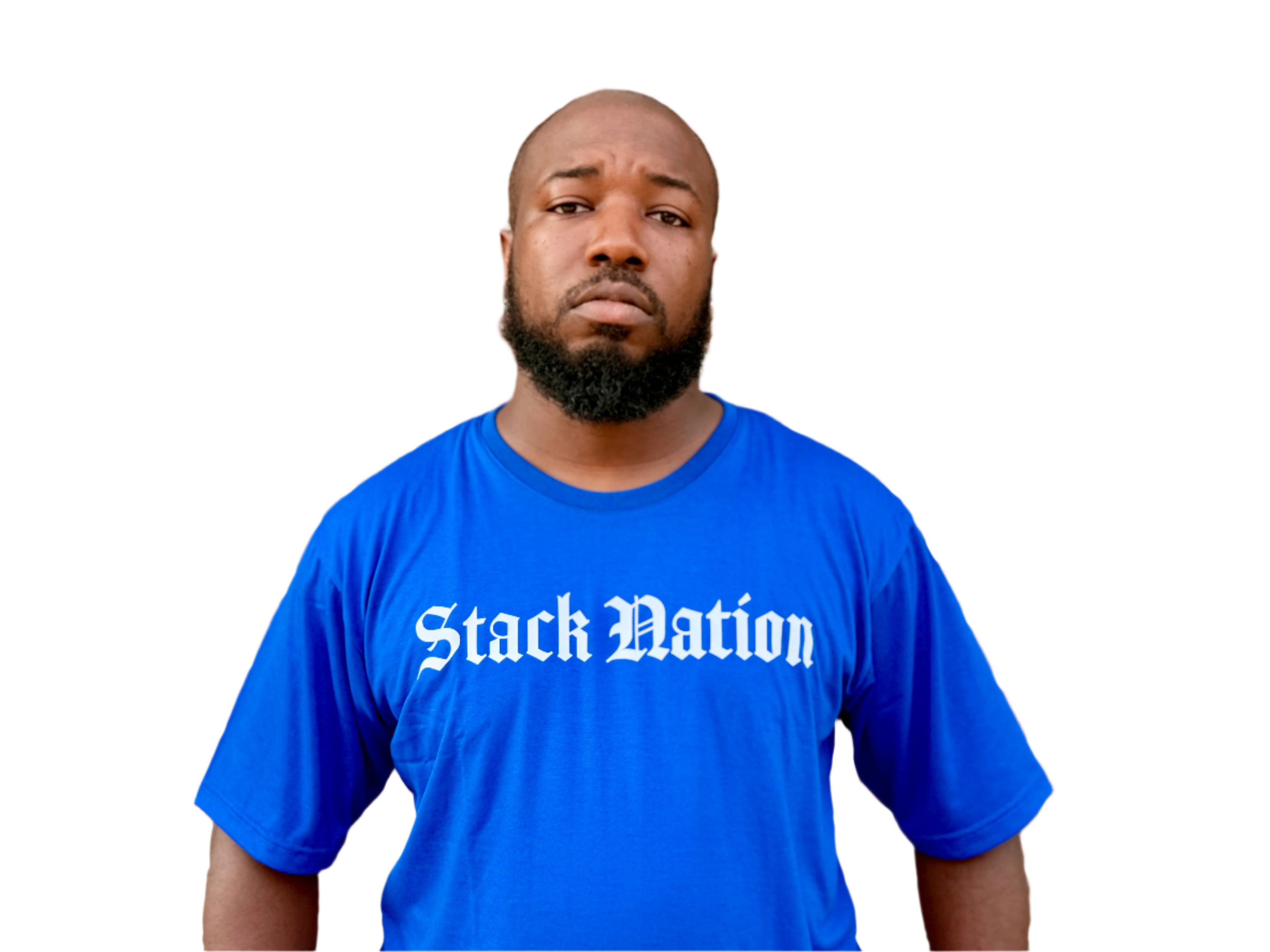 Man wearing a blue 'Stack Nation' t-shirt in front of a brick wall