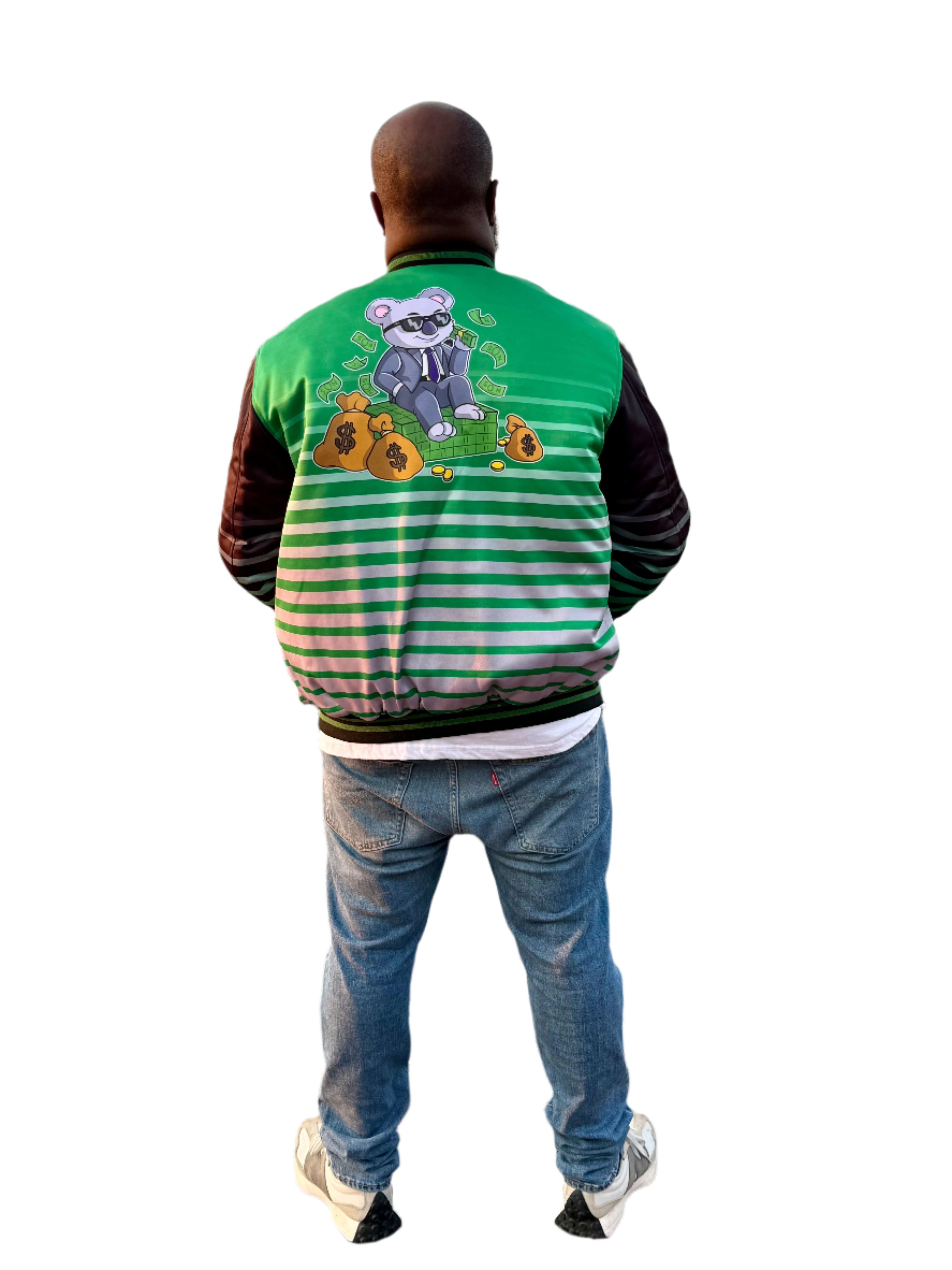 Person wearing a green and striped jacket with a cartoon character, standing by a waterfront.
