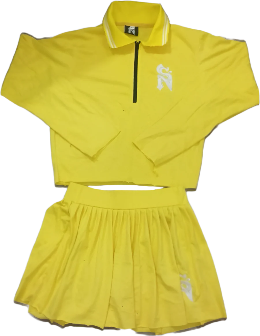 Yellow athletic outfit with a skirt and jacket on a gray background